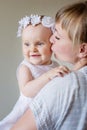 Mother and baby daughter plays, hugging, kissing at hom Royalty Free Stock Photo