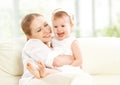 Happy family. Mother and baby daughter plays, hugging, kissing Royalty Free Stock Photo