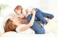 Happy family. Mother and baby daughter plays, hugging, kissing Royalty Free Stock Photo