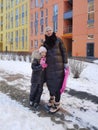 happy family mother and baby girl daughter playing and laughing in winter outdoors in the snow Royalty Free Stock Photo