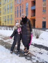 happy family mother and baby girl daughter playing and laughing in winter outdoors in the snow Royalty Free Stock Photo