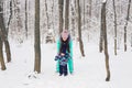Happy family mother and baby girl daughter playing and laughing in winter outdoors in the snow Royalty Free Stock Photo