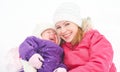 Happy family mother and baby girl daughter playing and laughing in winter snow Royalty Free Stock Photo