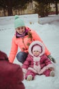 Happy family mother and baby girl daughter in winter outdoors Royalty Free Stock Photo