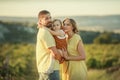 Happy family mother and baby hugging in a meadow yellow flowers on nature in summer Royalty Free Stock Photo