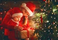 Happy family mother and baby near Christmas tree in holiday nigh Royalty Free Stock Photo