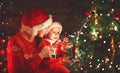 Happy family mother and baby near Christmas tree in holiday nigh Royalty Free Stock Photo