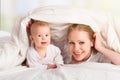 Happy family. Mother and baby playing under blanket Royalty Free Stock Photo