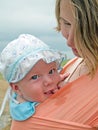 Happy family with mother and baby in sling