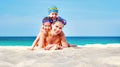 Happy family mother and chidren in masks on beach in summer