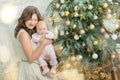 Happy family mother and child baby boy on Christmas morning at the tree with gifts, home decoration, interior house Royalty Free Stock Photo