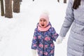 Happy family mother and child daughter having fun, playing at winter walk outdoors Royalty Free Stock Photo