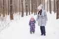 Happy family mother and child daughter having fun, playing at winter walk outdoors Royalty Free Stock Photo