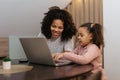 Happy family mother and child daughter at home working on the computer Royalty Free Stock Photo