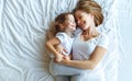 Happy family mother and child daughter laugh in bed Royalty Free Stock Photo