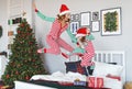 Happy family mother and child daughter in pajamas jumping in bed on on christmas morning Royalty Free Stock Photo
