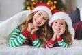 Happy family mother and child daughter in pajamas opening gifts Royalty Free Stock Photo