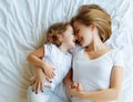 Happy family mother and child daughter laugh in bed Royalty Free Stock Photo