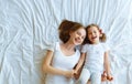 Happy family mother and child daughter laugh in bed Royalty Free Stock Photo