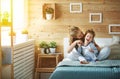 Happy family mother and child daughter laughing in bed Royalty Free Stock Photo