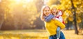 Happy family mother and child daughter on autumn walk