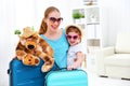 happy family mother and child daughter suitcases packed for vacation