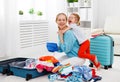 happy family mother and child daughter suitcases packed for vacation