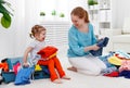 happy family mother and child daughter suitcases packed for vacation