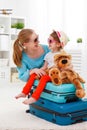 happy family mother and child daughter suitcases packed for vacation