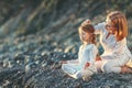 Happy family mother and child doing yoga, meditate in lotus position on beach Royalty Free Stock Photo