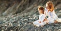 Happy family mother and child doing yoga, meditate in lotus position on beach Royalty Free Stock Photo
