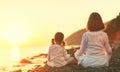 Happy family mother and child doing yoga, meditate in lotus position on beach Royalty Free Stock Photo
