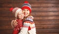 happy family mother and child girl with christmas hat hugs at wooden Royalty Free Stock Photo