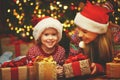 Happy family mother and child girl with Christmas present Royalty Free Stock Photo