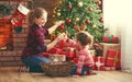 Happy family mother and child girl decorated Christmas tree