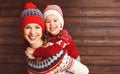 Happy family mother and child girl hugs at wooden background Royalty Free Stock Photo