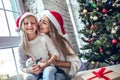 Happy family mother and child girl near a Christmas tree with Christmas present Royalty Free Stock Photo