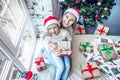 Happy family mother and child girl near a Christmas tree with Christmas present Royalty Free Stock Photo