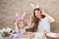 Happy family mother and child girl paints eggs for Easter at home Royalty Free Stock Photo