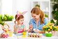 Happy family mother and child girl paints eggs for Easter Royalty Free Stock Photo