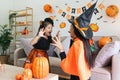 Happy family mother and child happy girl with Halloween at home together beautifully decorated. Mother teasingly playing Royalty Free Stock Photo