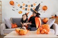 Happy family mother and child happy girl with Halloween at home together beautifully decorated. Mother teasingly playing Royalty Free Stock Photo