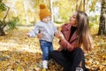 Happy family mother and child little boy walking in autumn park outdoors Royalty Free Stock Photo