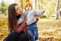 Happy family mother and child little boy walking in autumn park outdoors Royalty Free Stock Photo