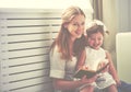Happy family mother child little girl reading book Royalty Free Stock Photo