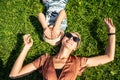 Happy family: mother and child son laughing, lying on the green grass in nature. Royalty Free Stock Photo