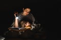 Happy family mother and child son reading a book with a flashlight. Family before going to bed mother reads to her child son book Royalty Free Stock Photo