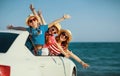 Happy family mother and children girls goes to summer travel trip in car