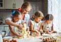 Happy family mother and children twins bake kneading dough in Royalty Free Stock Photo