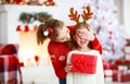 Happy family mother and daughter giving christmas gift